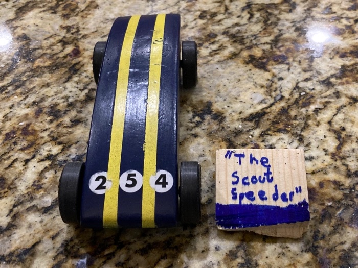 Blue and yellow Pinewood Derby car named The Scout Freedom